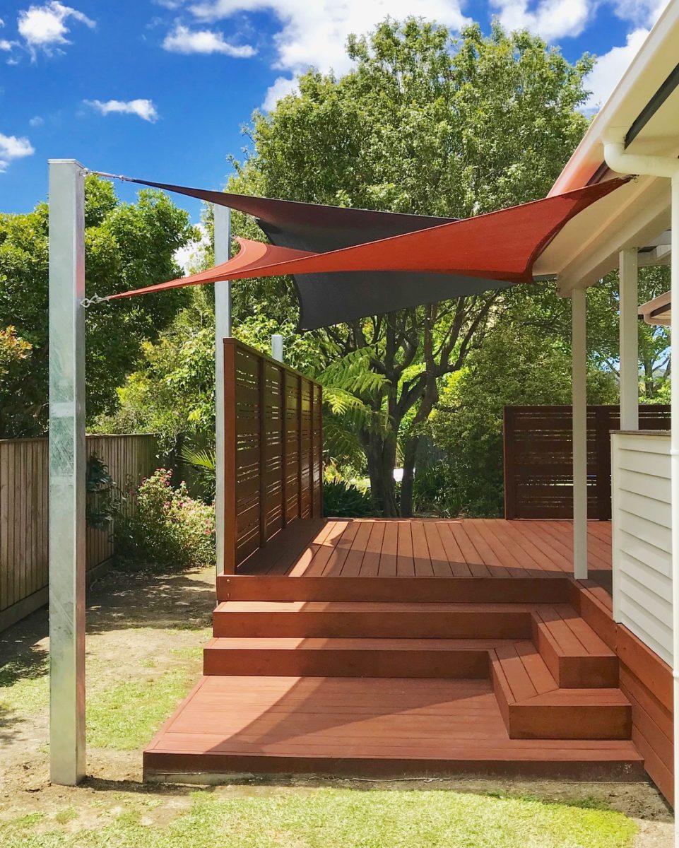 Shade sail over back deck creating a shady seating area