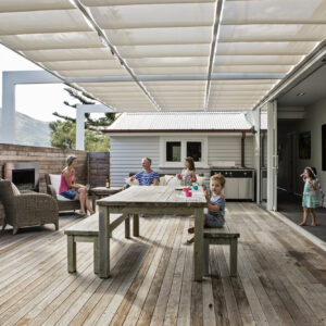 family living under wave shade awning
